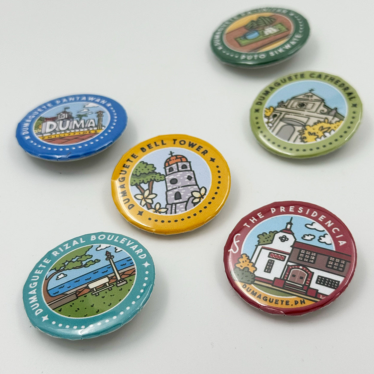 Button Pin, Duma, DumaGetMe, Dumaguete city, Negros Oriental, Souvenir, pins, art, artistic, creative, Kat Banay, Bell Tower, Pantawan, Cathedral, Pa-Initan, Rizal Boulevard, Iconic spots, tourist, touristic destinations, Landmarks, close up