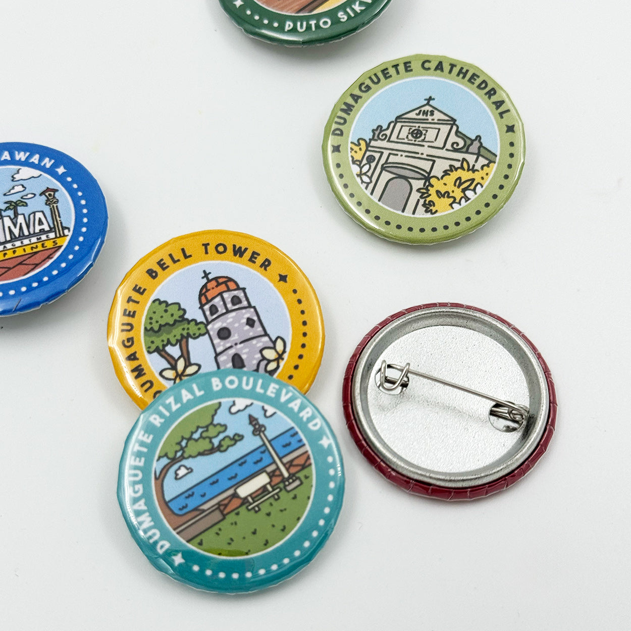 Button Pin, Duma, DumaGetMe, Dumaguete city, Negros Oriental, Souvenir, pins, art, artistic, creative, Kat Banay, Bell Tower, Pantawan, Cathedral, Pa-Initan, Rizal Boulevard, Iconic spots, tourist, touristic destinations, Landmarks, close up