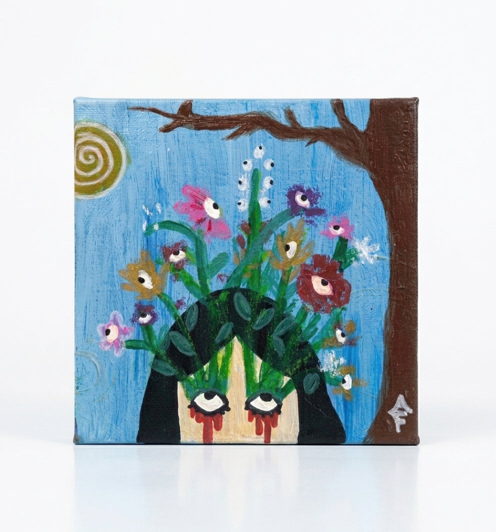 Angelika Faith, Mixed Media on Canvas, Micra flower, yellow, blue. Each print shows a colorful surreal floral illustration with a face and a caption: "WHAT IT KEPT ALIVE," "TEARS OF METAMORPHOSIS," "STILL, SHE BLOOMS," and "A CYCLE THAT GROWS.