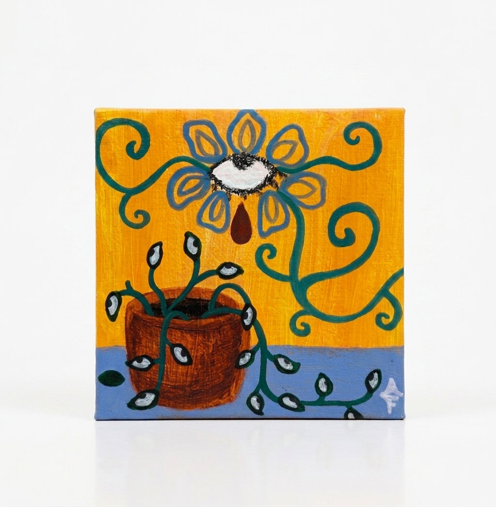 Angelika Faith, Mixed Media on Canvas, Micra flower, yellow, blue. Each print shows a colorful surreal floral illustration with a face and a caption: "WHAT IT KEPT ALIVE," "TEARS OF METAMORPHOSIS," "STILL, SHE BLOOMS," and "A CYCLE THAT GROWS.